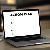 Laptop screen shows the header ‘action plan’ and underneath lists five action points, none of which contain text