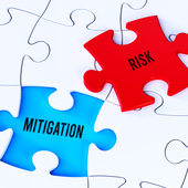 White jigsaw puzzle with displaced red piece that has the word Risk on it, which could fit into a blue gap that shows the word Mitigation