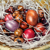 Chicken and quail eggs covered in metallic paint in a basket
