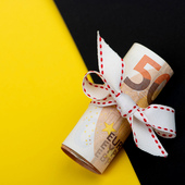 Euro notes are wrapped with string