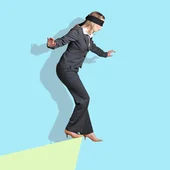 A businesswoman with a blindfold on is teetering at the edge of an abstract drop